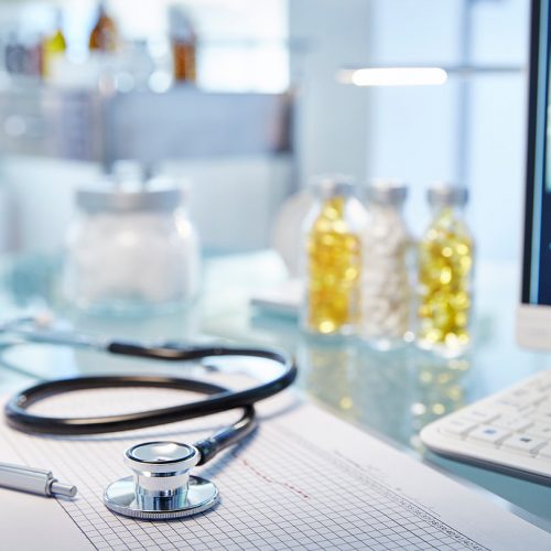 Chart and stethoscope on desk,x-ray on monitor